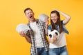 Young win couple, woman man, football fans holding bundle of dollars, cash money, soccer ball, cheer up support team Royalty Free Stock Photo