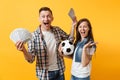 Young win couple, woman man, football fans holding bundle of dollars, cash money, soccer ball, cheer up support team Royalty Free Stock Photo