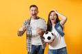 Young win couple, woman man, football fans holding bundle of dollars, cash money, soccer ball, cheer up support team Royalty Free Stock Photo