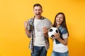 Young win couple, woman man, football fans holding bundle of dollars, cash money, soccer ball, cheer up support team Royalty Free Stock Photo