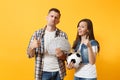 Young win couple, woman man, football fans holding bundle of dollars, cash money, soccer ball, cheer up support team Royalty Free Stock Photo