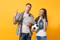 Young win couple, woman man, football fans holding bundle of dollars, cash money, soccer ball, cheer up support team Royalty Free Stock Photo