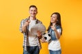 Young win couple, woman man, football fans holding bundle of dollars, cash money, soccer ball, cheer up support team Royalty Free Stock Photo