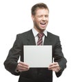 Young winking businessman holding sign Royalty Free Stock Photo