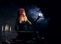 Young witch making witchcraft on a Halloween background Royalty Free Stock Photo