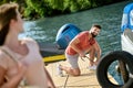 A young womaan standing on the dock while her man untying the boat Royalty Free Stock Photo