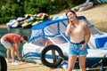 A young womaan standing on the dock while her man untying the boat Royalty Free Stock Photo