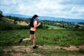 Young women active trail runners the top of a mountain in the afternoon, ultra marathon runners adventuring outdoors