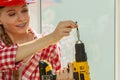 Young woman adjusting her drill Royalty Free Stock Photo