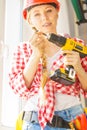 Young woman adjusting her drill doing Royalty Free Stock Photo