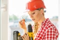 Young woman adjusting her drill doing Royalty Free Stock Photo