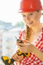 Young woman adjusting her drill doing Royalty Free Stock Photo