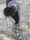 Young woman adjusting orthopedic boot used in rehabilitation for foot injury, fracture or ankle sprain. Patient walking down the