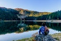 Young woman admires beautiful panorama of Black Lake ( Crno jezero),Durmitor, Montenegro Royalty Free Stock Photo