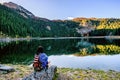 Young woman admires beautiful panorama of Black Lake ( Crno jezero),Durmitor, Montenegro Royalty Free Stock Photo