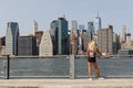 A young woman admires the view of Manhattan skyline