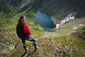 Young woman admiring a beautiful glacial lake