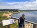 A young woman admiring the beautiful views monterey bay beside pebble beach golf course, on a beautiful spring day in California Royalty Free Stock Photo