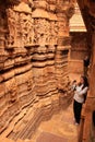 Young woman admiring interior of Jain temple, Jaisalmer, Rajasthan, India