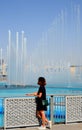 Young woman admiring the show of the Dubai Fountain, UAE Royalty Free Stock Photo