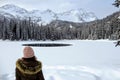 A young woman admiring the snowy views of Island Lake in Fernie, British Columbia, Canada.The majestic winter background is pretty Royalty Free Stock Photo