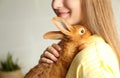 Young woman with adorable rabbit, closeup. Lovely pet