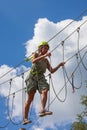 Young woman in adventure park summer challenge Royalty Free Stock Photo