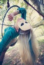 Woman aerial hoop dance in forest with mask on face Royalty Free Stock Photo
