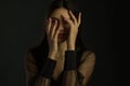 The young woman is afraid, depressed, and covers her face with her hands Royalty Free Stock Photo