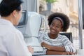 Young woman african american examining eyesight modern measurement machine equipment by eye specialist in clinic. ophthalmologist Royalty Free Stock Photo