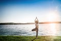 Young woman against sunset and lake water Royalty Free Stock Photo