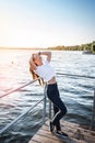 Young woman against sunset and lake water Royalty Free Stock Photo