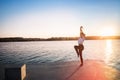 Young woman against sunset and lake water Royalty Free Stock Photo