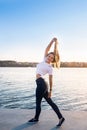 Young woman against sunset and lake water Royalty Free Stock Photo