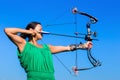 Young woman aiming arrow of compound bow Royalty Free Stock Photo