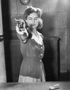 Young woman aiming with a handgun