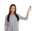 Young woman with air conditioner remote on white Royalty Free Stock Photo