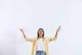 Young woman with air  remote on white background Royalty Free Stock Photo