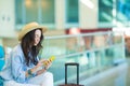 Young woman in an airport lounge waiting for flight aircraft. Caucasian woman with smartphone in the waiting room Royalty Free Stock Photo