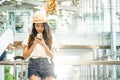 Young woman in airport waiting for air travel using smart phone.