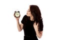 Young woman with alarmclock, isolated. Royalty Free Stock Photo