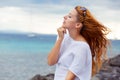 Young woman alone outdoors enjoying sea Royalty Free Stock Photo