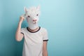 Young woman in alpaca mask scratching head, thinking or in doubt