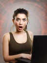 Young woman amazed and shocked by internet news