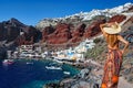 A woman at Amoudi bay below Oia village in Santorini, Greece Royalty Free Stock Photo