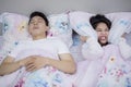 Young woman annoyed by her snoring husband