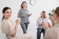 young woman applauding and looking at Royalty Free Stock Photo