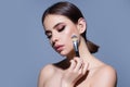 Young woman applies powder on the face using makeup brush. Beautiful girl doing contouring apply blush on cheeks. Face Royalty Free Stock Photo