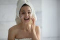 Young woman apply revitalizing cream on face in bath Royalty Free Stock Photo