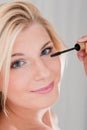 Young woman applying black eye mascara Royalty Free Stock Photo